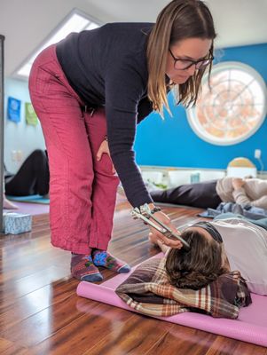 Using a weighted tuning fork on the head for a calming and grounding