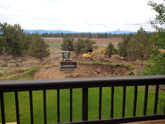 Pond construction.  Digging, grading, breaking rock