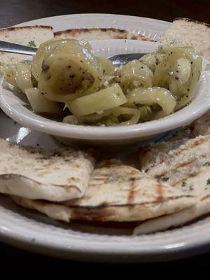 Hot peppers in oil served with fresh baked warm seasoned pita bread