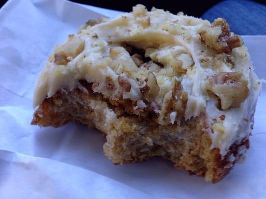 Pumpkin donut with cream cheese frosting topped with walnuts. AMAZING