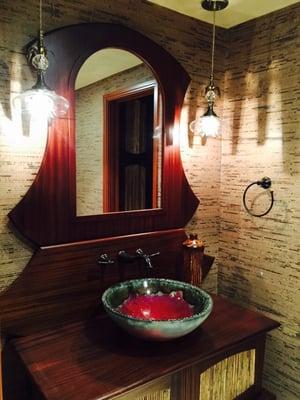 Guests will feel inspired by this custom-designed vanity for a funky, Oriental-inspired powder room with handmade vessel sink.