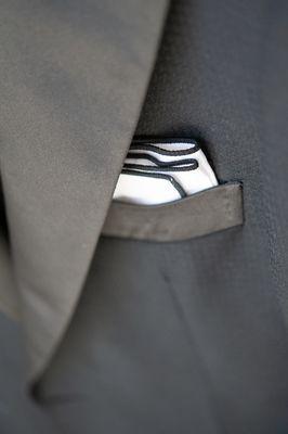 Hand stitching details on a timeless formal black tuxedo.