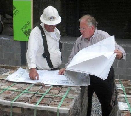 Jim Odle is working with the contractor on site to explain a drawing detail.