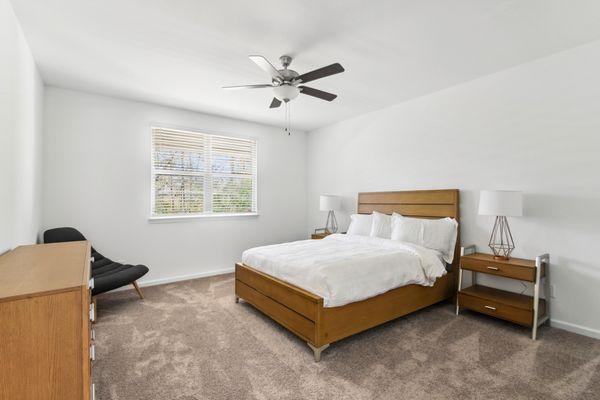 Primary bedroom with ceiling fan.