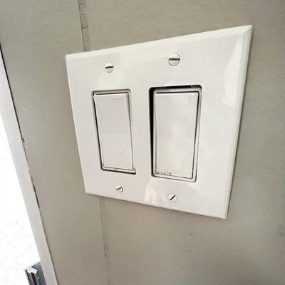 Poor quality workmanship in changing light switches from old yellowed to bright white, note indentation.