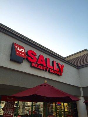 Outside View Of Sally's In The Shopping Center. Located To The Left Of The Grocery Store.