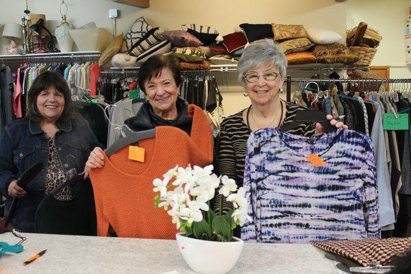 Sharon (right) with volunteers in Receiving Room get clothing ready for the store.