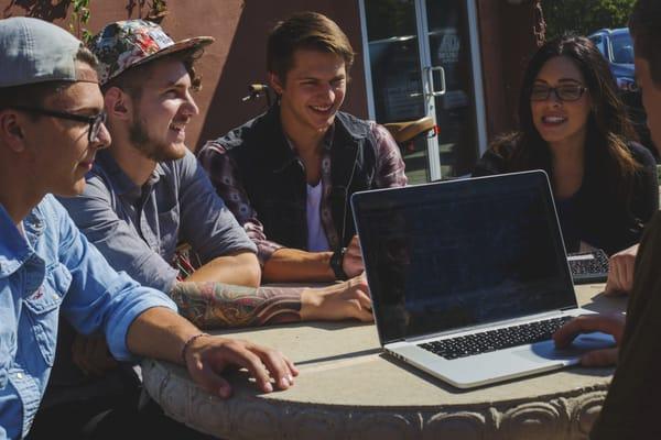 Music Business students having and outdoor meeting.