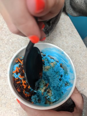 Cookie monster ice cream with black and orange Halloween sprinkles