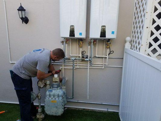 Cory with a y working on installation of tankless water heater