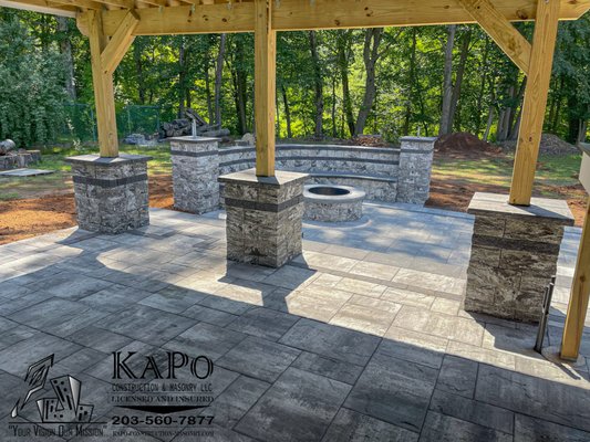 Cambridge Ledgestone Limestone Quarry blend Paver Patios with Pillars and Seating Bench including a woodburning firepit done in Plantsville