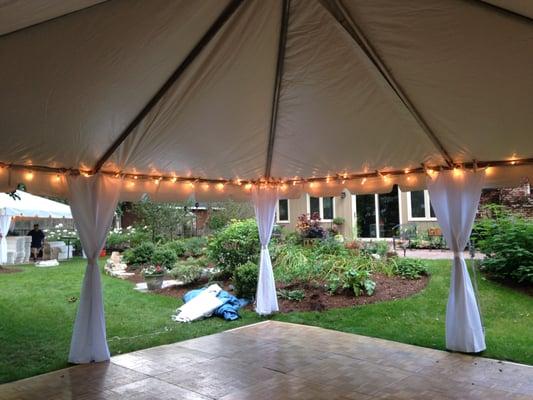 30x40 Frame tent with white leg drapes and cafe perimeter lighting