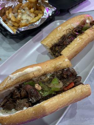 Oxtail cheesesteak and cheese fries.