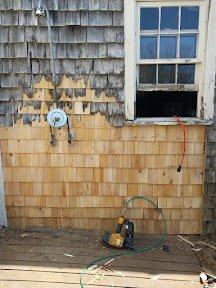 Removed all the rotted area. Framed in a new wall, sheathing and tied cedar shakes into the existing wall