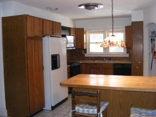 Small kitchen before removing walls to combine two rooms and a hall for a much larger kitchen.