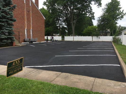 Parking lot seal coating and line striping.