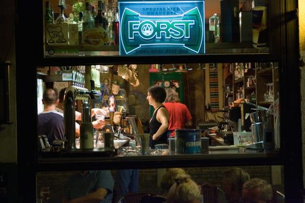 A bar maid stands in a bar in Venice, Italy.