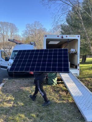 SAVKAT crew installing 25 SunPower Maxeon panels.