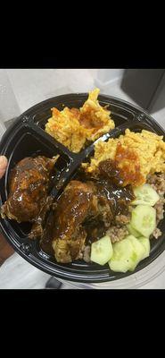 Grilled sweet and spicy chicken with cheesy baked Mac and Guyanese cook-up rice.