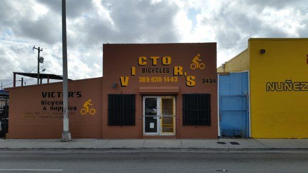 parking is on the side of the yellow building.