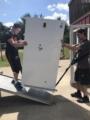 Kyle (owner) and Brayden moving this heavy upright freezer like it was weightless, and with an amazing upbeat attitude to boot!