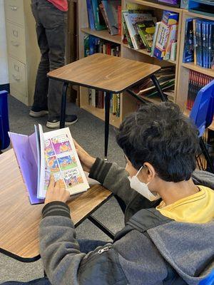 A Student Reading A Comic