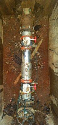 Backflow preventer in an underground pit.