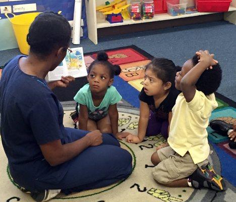 Exploring books and stories during interactive circle time helps children learn to read and express their imaginative ideas.