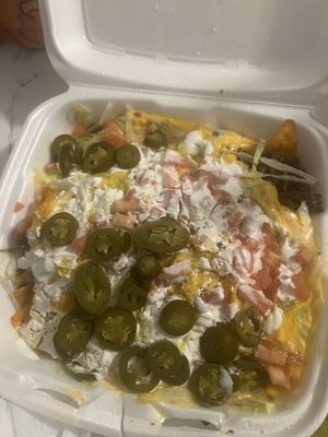 A cold nacho with tomatoes that I asked to not be on the order!