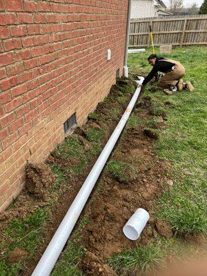 Installing downspout extensions.