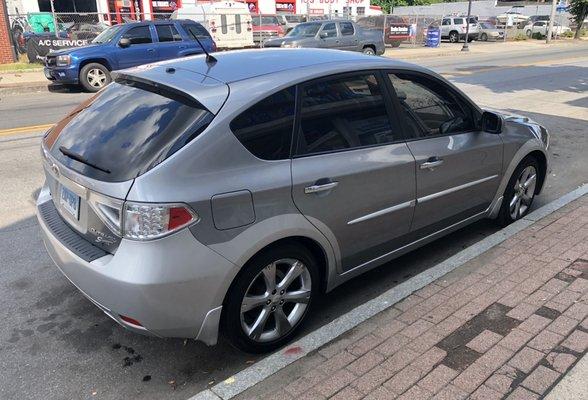 2011 Subaru Outback Impreza with all side windows tinted.