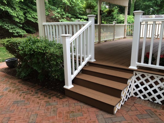 Trex deck floor in Beach Dune with White Trex railing and post sleeve caps.