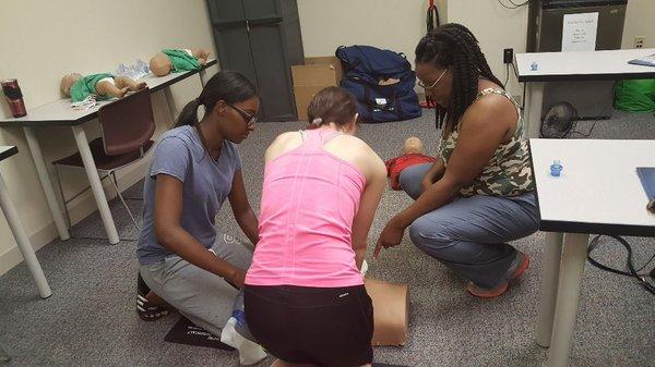 Students learning how to give chest compressions and airway management as part of a team.