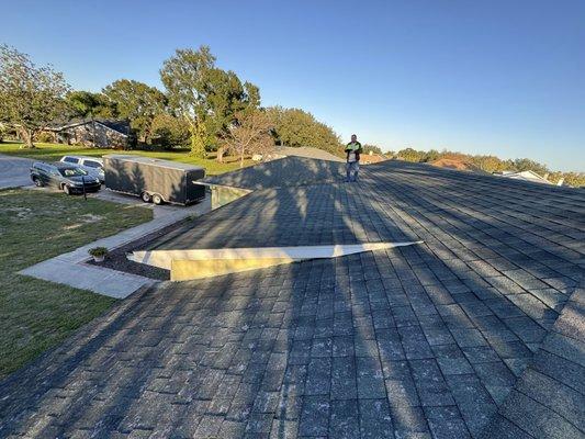 American Roofing FL contractor standing on the newly installed roof.