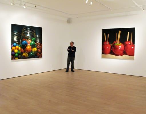 Director contemplating "MARGERT MORRISON: Larger Than Life" paintings