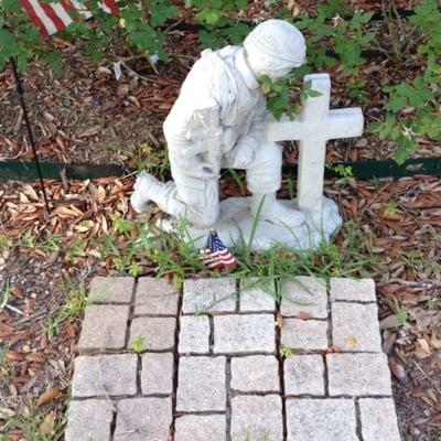 Soldier praying for fellow soldier