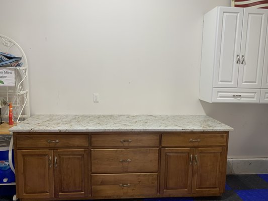 Old island cabinets set up in party room with new light quartz countertop