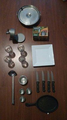 All this for $60: Steak knives (high quality), China, Glasses, Ladle, Dipping sauce thingies (?), Burger patty maker, Cast iron, Pot