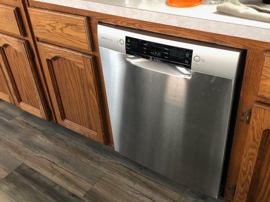 A dishwasher and a cabinet cut in half to make it fit.