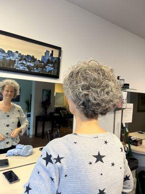 Client looking in the mirror admiring her new look