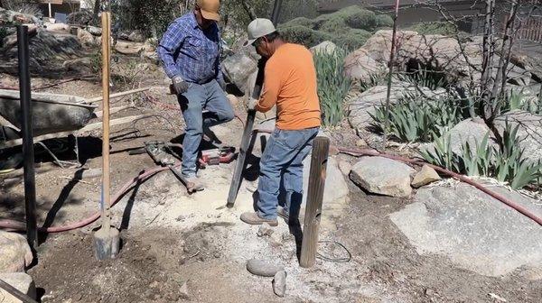 Setting the fourteenth of twenty-two steel fence posts