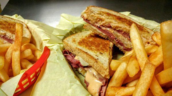 Reuben sandwich with a side of fries