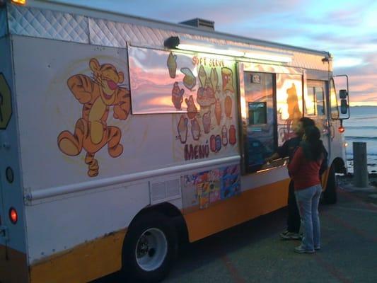 Beautiful ice cream truck in front of a beautiful sunset.