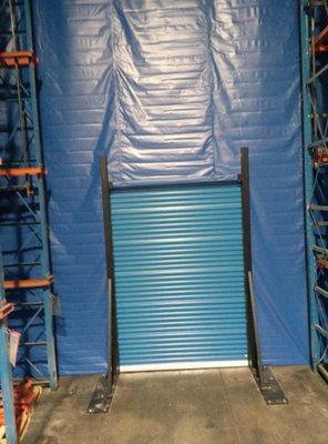 WAREHOUSE DIVIDER WITH ROLLING SHEET DOOR