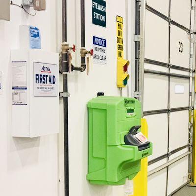 Warehouse First Aid Cabinet & Eyewash Station with signage