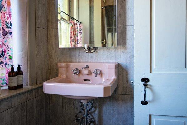 Vintage pink bath fixtures can be found in the Eberlein bathroom.