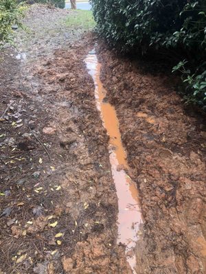 One of the drain pipes they installed - obviously not working....they "fixed" it by extending it but ending in a closed basin (now floating)