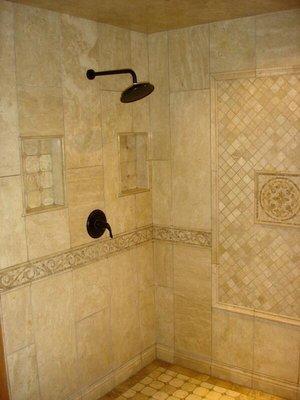 12 x 36 polished travertine shower with vertical running bond pattern.