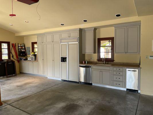 Garage cabinets refinished in a lacquer beige color.