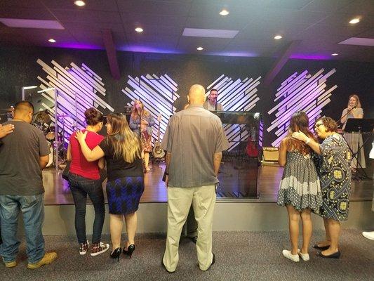 Before the end of service, people come up to receive prayer.